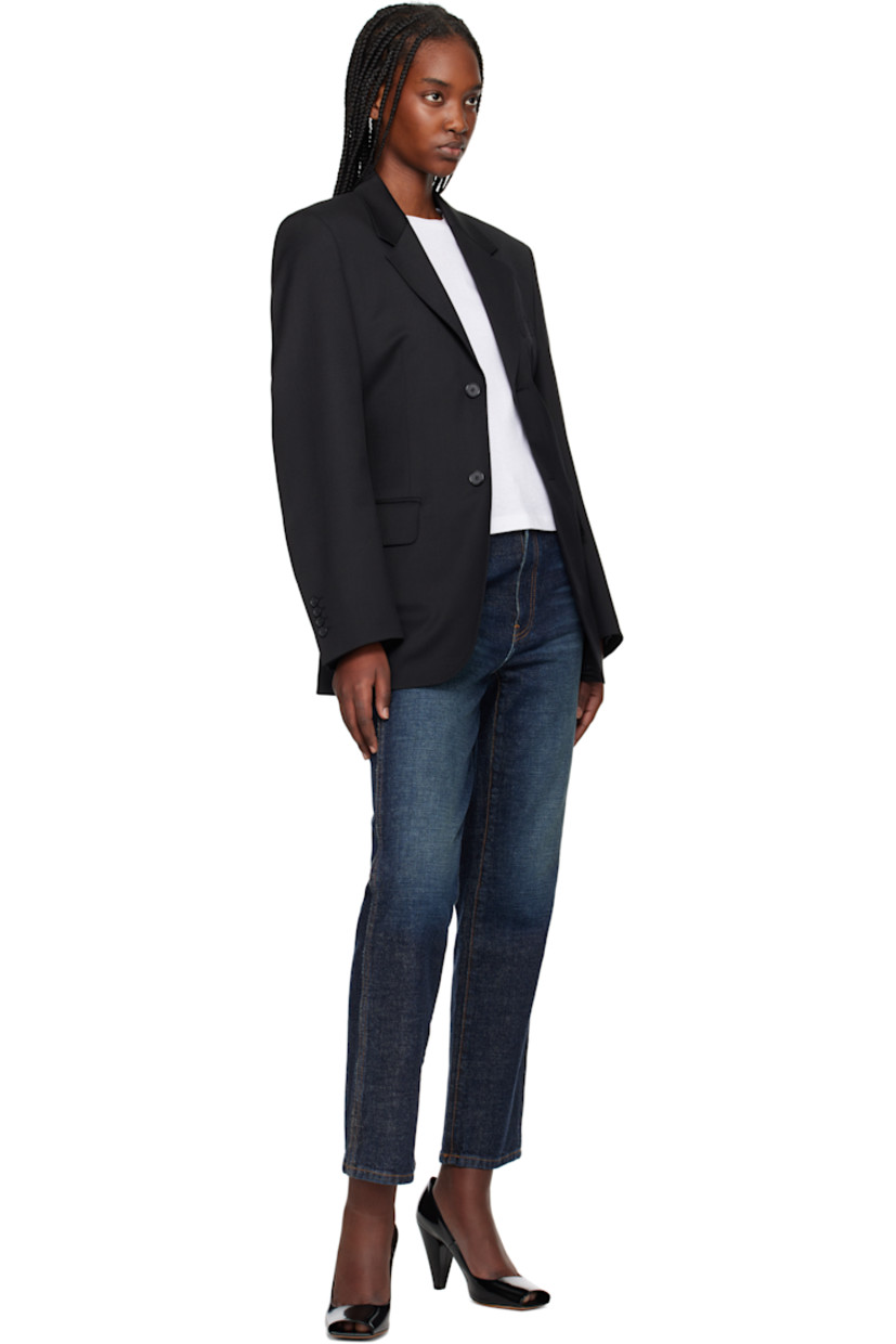 Polyester- and wool-blend twill blazer.

· Notched lapel
· Button closure
· Welt pocket at chest
· Flap pockets
· Padded shoulders
· Four-button surgeon's cuffs
· Central vent at back hem
· Welt pocket at interior
· Full satin lining

Supplier color: Black