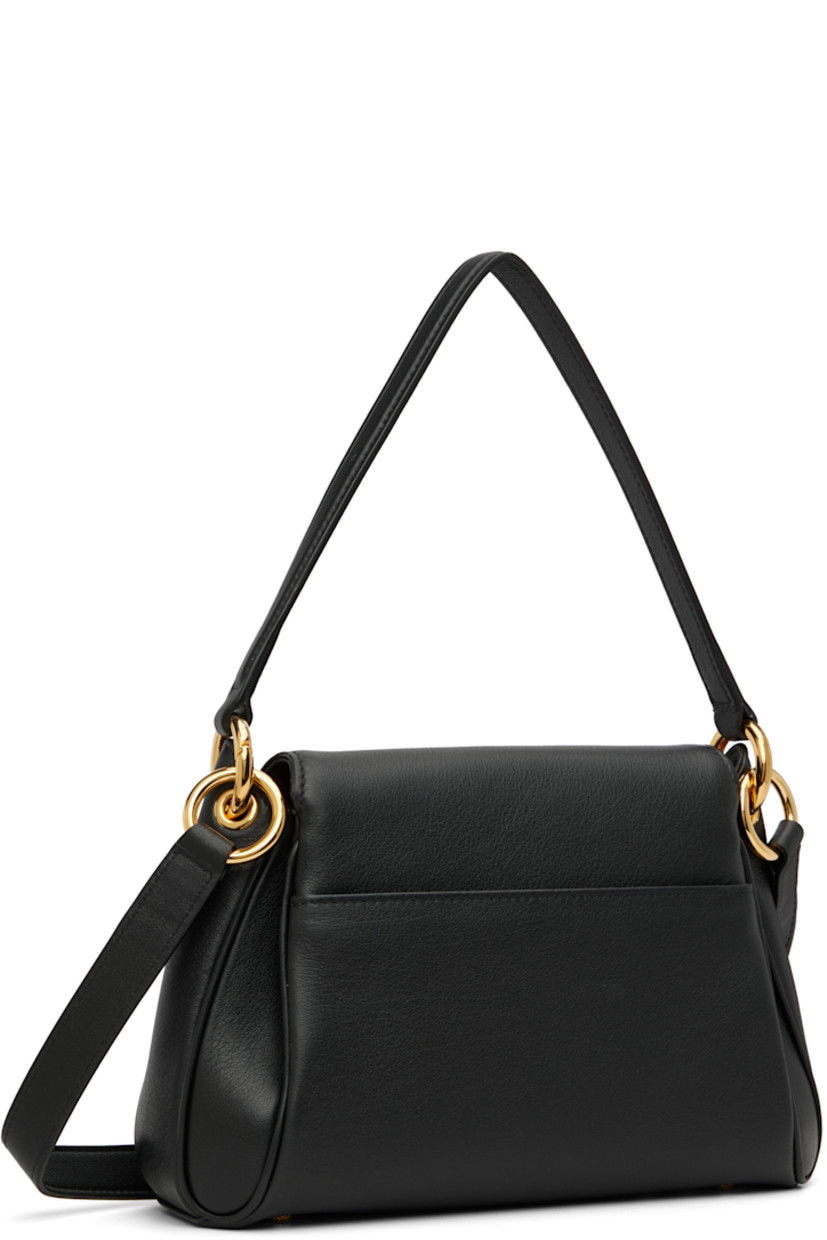 Grained calfskin shoulder bag.

· Detachable carry handle
· Adjustable and detachable crossbody strap
· Patch pocket at back face
· Bumper studs at base
· Logo hardware at magnetic flap
· Patch pocket at interior
· Faux-suede lining
· Logo-engraved gold-tone hardware
· H6.5" x W9" x D3"

Supplier color: Black