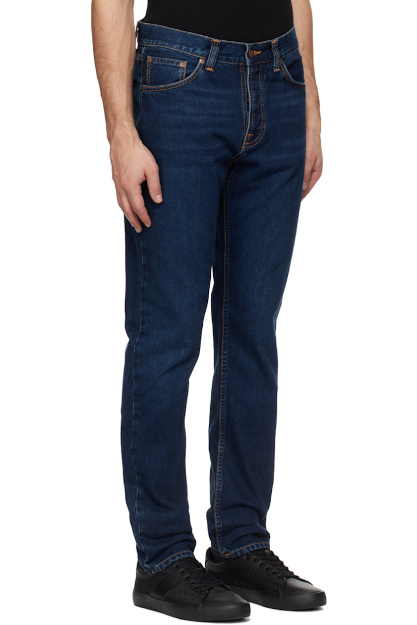 Slim-fit and tapered 13.3 oz non-stretch organic cotton denim jeans. Fading and whiskering throughout.

· Mid-rise
· Belt loops
· Five-pocket styling
· Button fly
· Jacron logo patch at back waistband
· Logo patch at back pocket
· Logo-engraved brass-tone hardware
· Contrast stitching in orange

Supplier color: Indigo nights