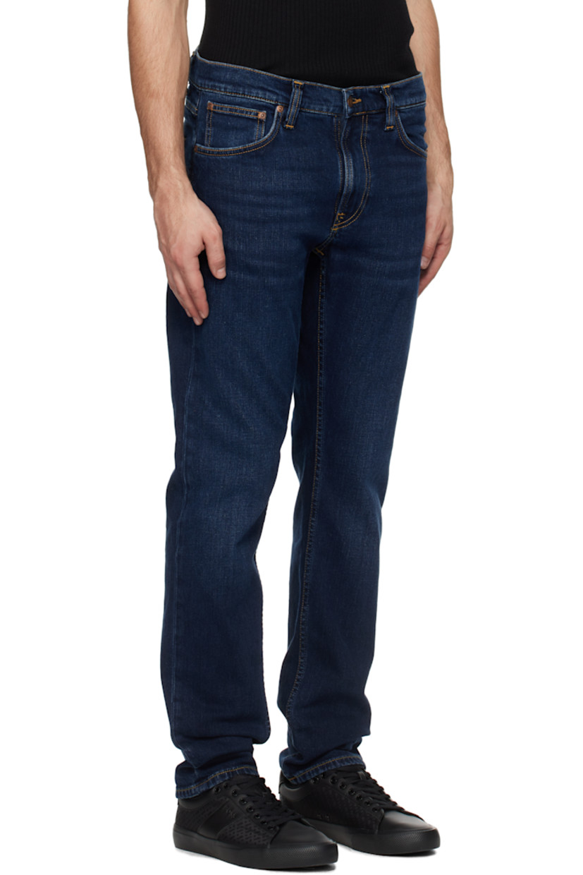 Slim-fit and tapered 12 oz stretch denim jeans. Fading and whiskering throughout. 

· Mid-rise
· Belt loops
· Five-pocket styling
· Zip-fly
· Jacron logo patch at back waistband
· Logo patch at back pocket
· Topstitching at back pockets
· Logo-engraved brass-tone hardware
· Contrast stitching in tan

Supplier color: New ink