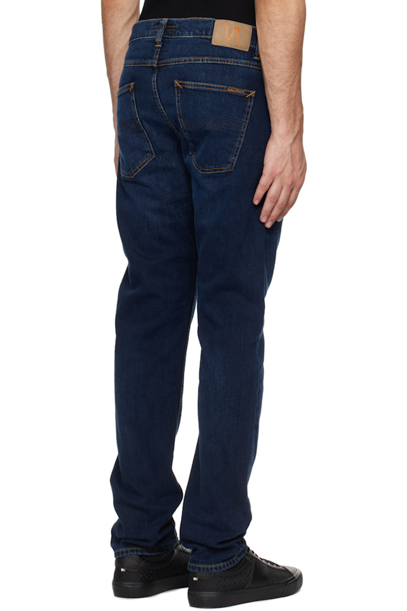 Slim-fit and tapered 12 oz stretch denim jeans. Fading and whiskering throughout. 

· Mid-rise
· Belt loops
· Five-pocket styling
· Zip-fly
· Jacron logo patch at back waistband
· Logo patch at back pocket
· Topstitching at back pockets
· Logo-engraved brass-tone hardware
· Contrast stitching in tan

Supplier color: New ink