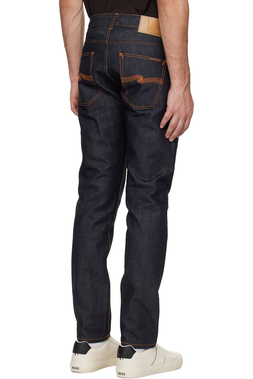 13 oz stretch organic cotton selvedge denim jeans. 

· Slim-fit and tapered
· Mid-rise
· Belt loops
· Five-pocket styling
· Zip-fly
· Jacron logo patch at back waistband
· Logo patch at back pocket
· Logo-engraved antiqued silver-tone hardware
· Contrast stitching in orange

Supplier color: Dry Japan selvage
