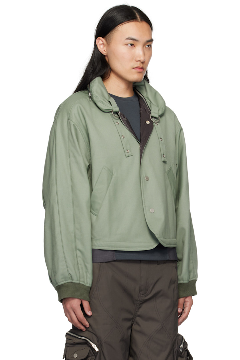 Wool-blend twill jacket.

· Drawstring and laser-cut logo at stowaway hood
· Detachable stand collar
· D-rings and press-stud throat guard at collar
· Press-stud closure
· Welt pockets
· Bungee-style drawstring at cropped hem
· Dropped shoulders
· Rib-knit cuffs
· Inverted box pleats at back
· Full cupro satin lining

Supplier color: Tokyo green