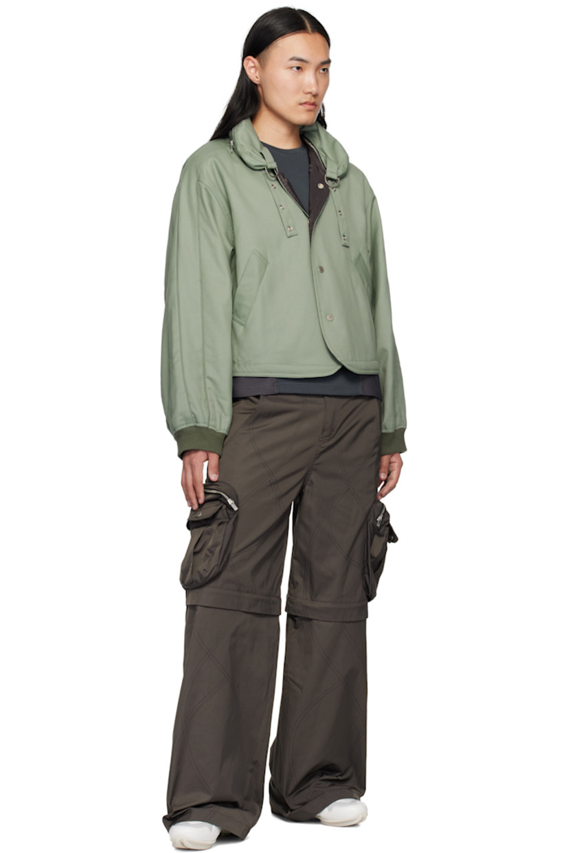 Wool-blend twill jacket.

· Drawstring and laser-cut logo at stowaway hood
· Detachable stand collar
· D-rings and press-stud throat guard at collar
· Press-stud closure
· Welt pockets
· Bungee-style drawstring at cropped hem
· Dropped shoulders
· Rib-knit cuffs
· Inverted box pleats at back
· Full cupro satin lining

Supplier color: Tokyo green