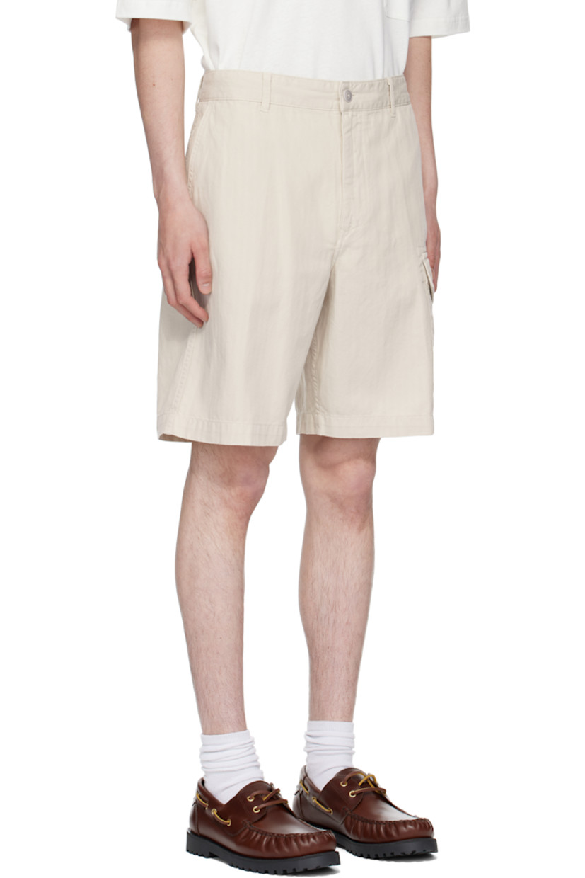 Loose-fit cotton- and linen-blend herringbone cargo shorts. 

· Better Cotton™-certified and garment-dyed 
· Belt loops
· Four-pocket styling
· Zip fly
· Flap pocket at outseam
· Logo patch at back waist

Supplier color: Stone beige