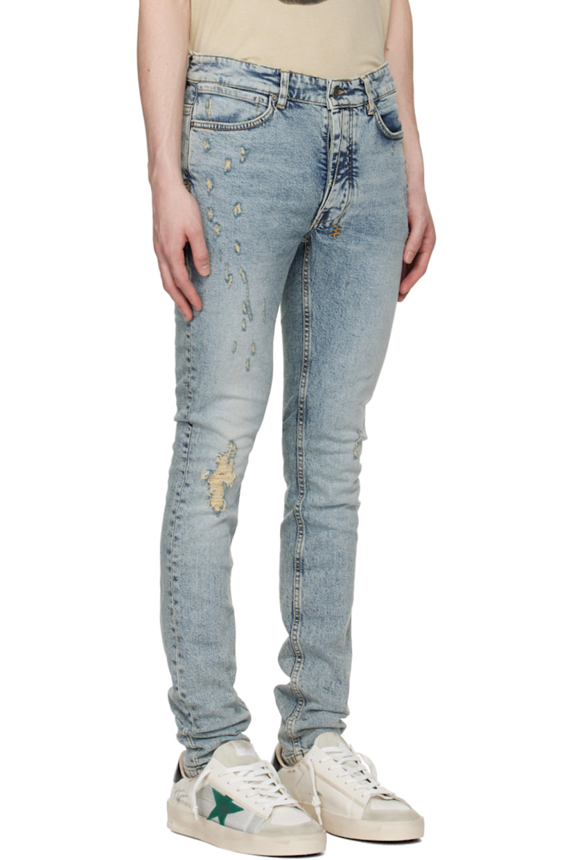 Skinny-fit stretch denim jeans. Fading, whiskering, and subtle distressing throughout.

· Belt loops
· Five-pocket styling
· Button fly
· Logo graphics embroidered at back waist and leg
· Logo patch at back pocket
· Logo-engraved gunmetal-tone hardware
· Contrast stitching in tan

Supplier color: Rogue blue scatter