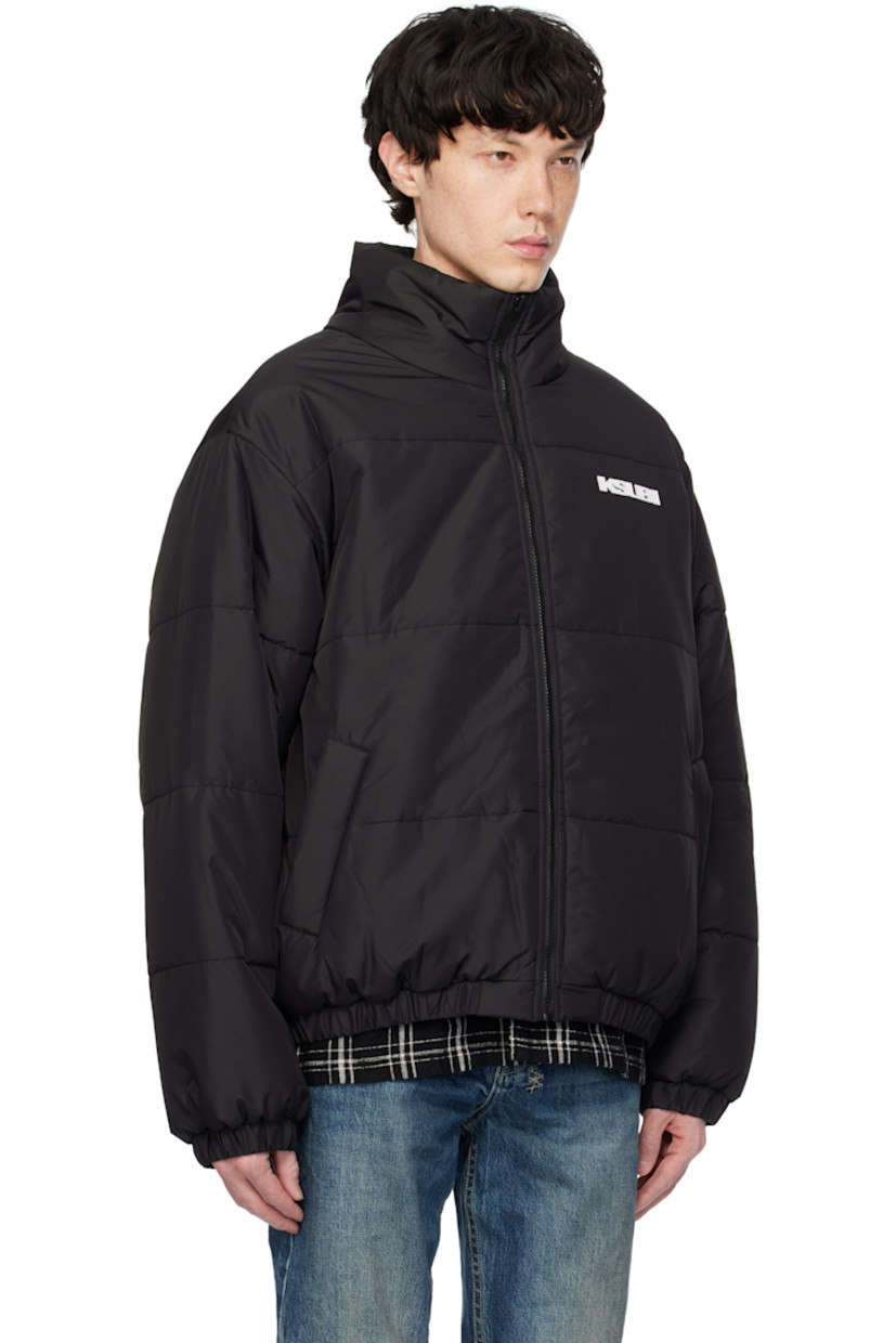 Reversible padded quilted polyester satin jacket. 

Reverse in black polyester satin. Logo bonded at back collar.

· Stand collar
· Zip closure
· Logo bonded at chest and side seam
· Zip pockets
· Elasticized hem and cuffs
· Logo flag at cuff

Supplier color: Black