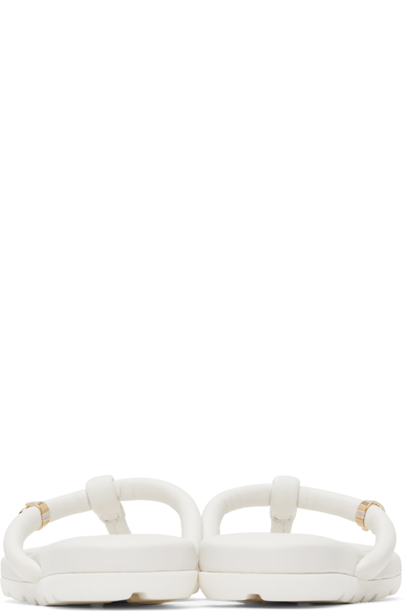 Handcrafted nappa leather flat sandals in white.

· Open toe
· Padded thong-style strap at vamp
· Logo hardware at strap
· Logo stamp at padded footbed
· Treaded rubber sole
· Gold-tone hardware

Supplier color: White