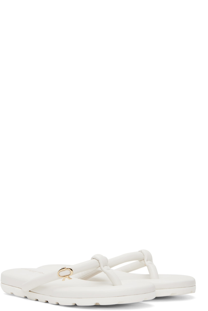 Handcrafted nappa leather flat sandals in white.

· Open toe
· Padded thong-style strap at vamp
· Logo hardware at strap
· Logo stamp at padded footbed
· Treaded rubber sole
· Gold-tone hardware

Supplier color: White