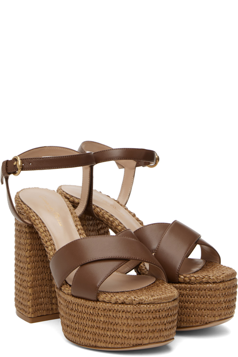 Handcrafted nappa leather heeled sandals in brown.

· Open toe
· Crisscrossing straps at vamp
· Pin-buckle ankle strap
· Logo stamp at padded footbed
· Buffed leather lining
· Woven raffia heel and platform midsole
· Block heel with rubber injection
· Leather sole
· Platform: H2"
· Heel: H4.75"

Supplier color: Cuoio/Cuoio