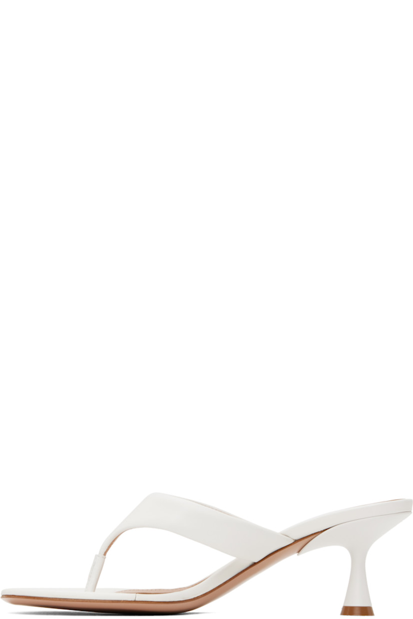 Handcrafted nappa leather heeled sandals in white.

· Open toe
· Thong-style strap at vamp
· Logo hardware at strap
· Logo stamp at padded footbed
· Buffed leather lining
· Lacquered heel with rubber injection
· Polished leather sole
· Gold-tone hardware
· Heel: H2.25"

Supplier color: White