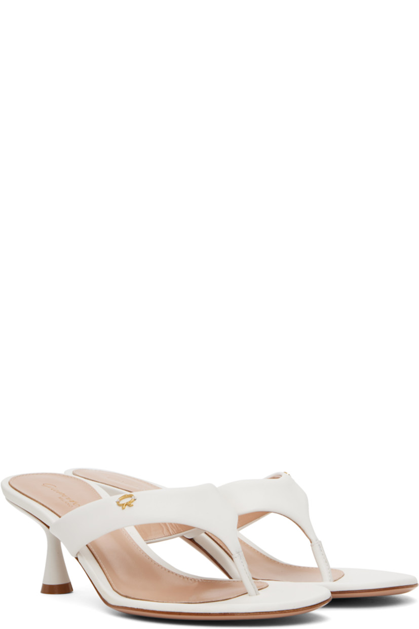 Handcrafted nappa leather heeled sandals in white.

· Open toe
· Thong-style strap at vamp
· Logo hardware at strap
· Logo stamp at padded footbed
· Buffed leather lining
· Lacquered heel with rubber injection
· Polished leather sole
· Gold-tone hardware
· Heel: H2.25"

Supplier color: White