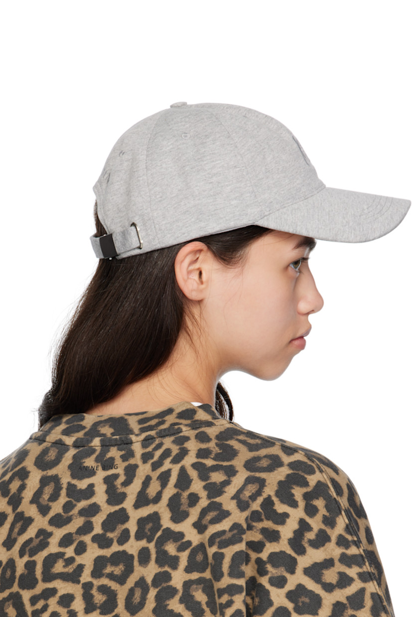 Handcrafted cotton jersey cap.

· Embroidered eyelets at crown
· Logo embroidered at face and back
· Curved brim 
· Cinch fastening
· Jersey browband 

Supplier color: Heather grey