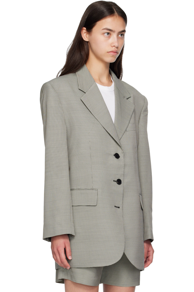 Plain-woven wool- and viscose-blend blazer. 

· Houndstooth pattern throughout 
· Notched lapel 
· Button closure
· Welt pocket at chest
· Flap pockets at front 
· Padded shoulders
· Buttoned surgeon's cuffs
· Central vent at back hem 
· Welt pockets at interior 
· Full viscose-blend satin lining

Supplier color: Black/White mini houndstooth