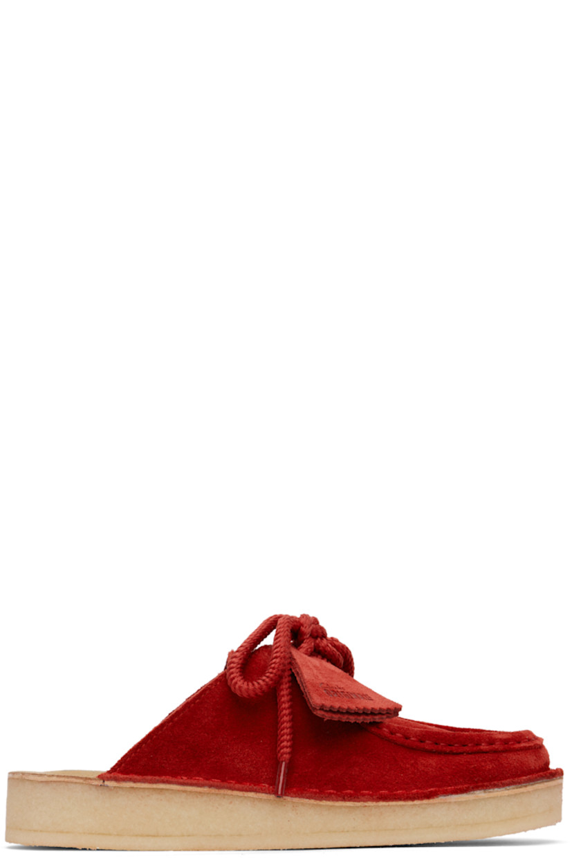 Suede mules in red.

· Bellows tongue
· Logo stamp at molded footbed
· Grained leather lining
· Crêpe rubber sole

Supplier color: Red suede