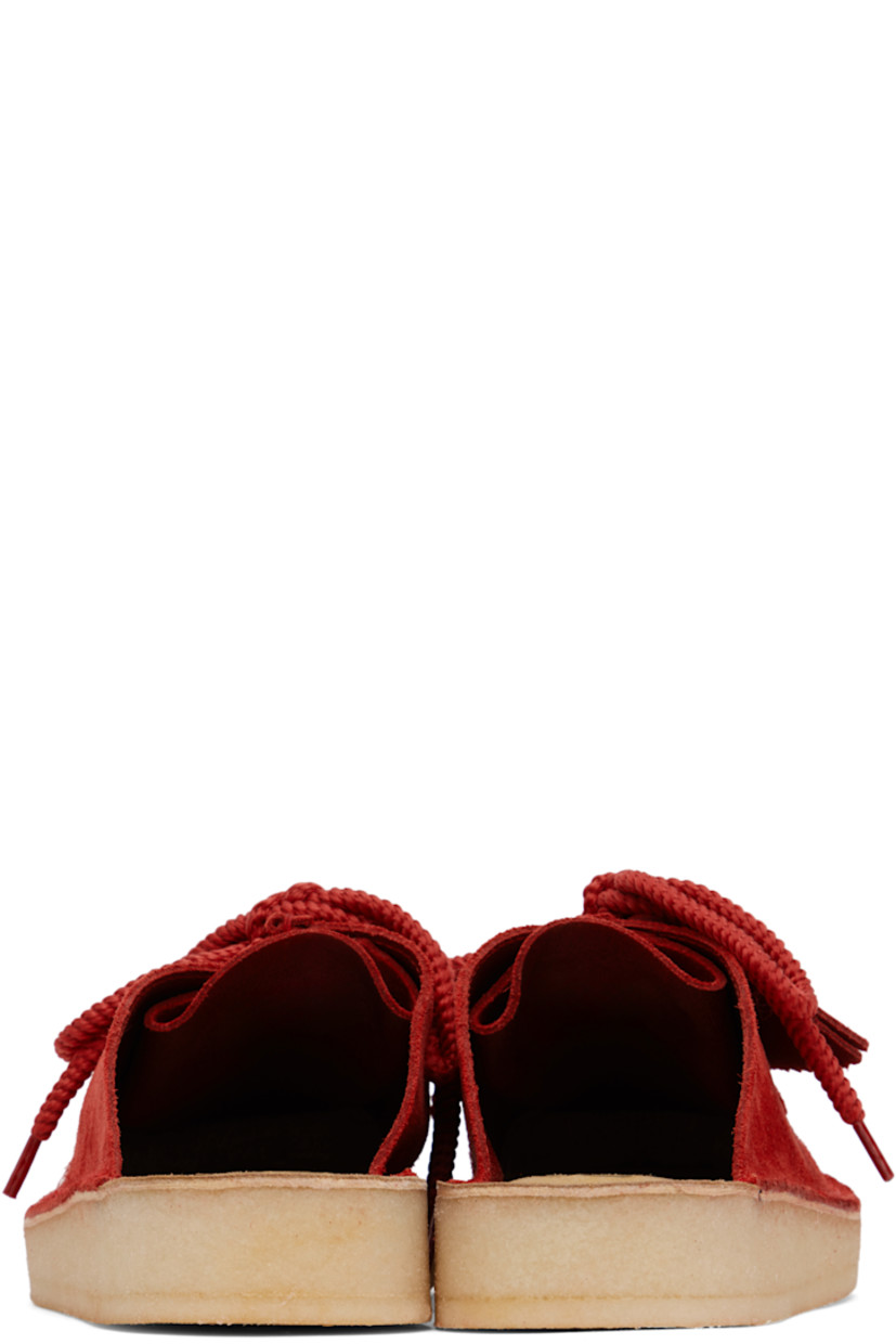 Suede mules in red.

· Bellows tongue
· Logo stamp at molded footbed
· Grained leather lining
· Crêpe rubber sole

Supplier color: Red suede