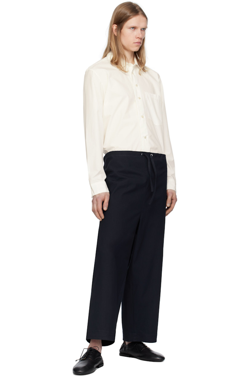 Cotton canvas trousers. 

· Drawstring at waistband 
· Two-pocket styling 
· Embroidered detailing at cuffs 
· Gusset at inseam 

Supplier color: Canvas navy