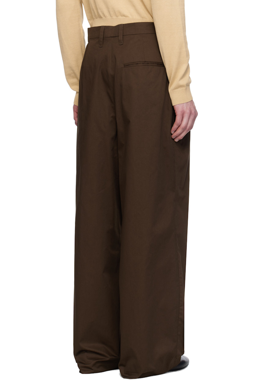 Wide straight-leg cotton twill trousers. 

· Belt loops 
· Three-pocket styling 
· Zip fly 
· Asymmetric pleats at front 
· Dropped inseam
· Darts at back waistband 
· Horn hardware 

Supplier color: Brown