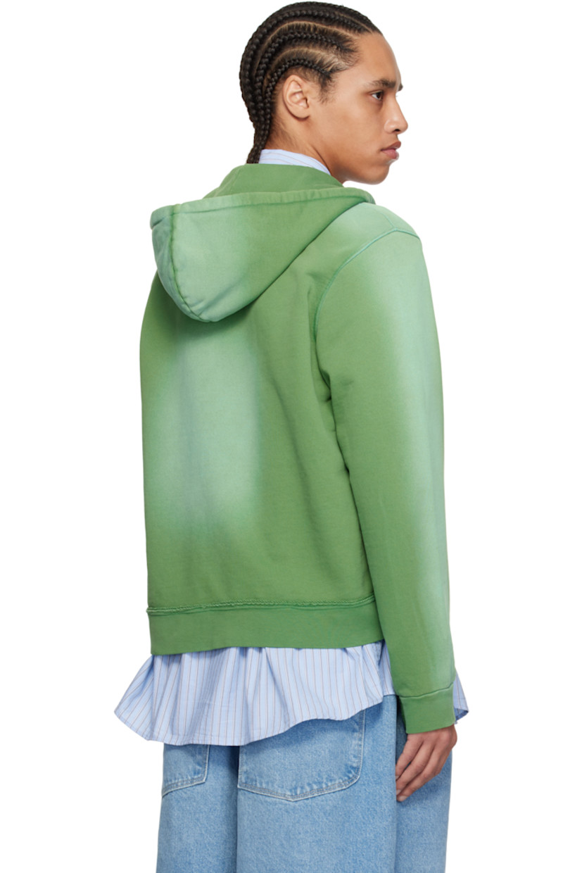 French terry hoodie. Fading and raw edges throughout.

· Cord-lock drawstring at hood
· Zip closure
· Asymmetric patch pockets and hem

Supplier color: Green sun faded