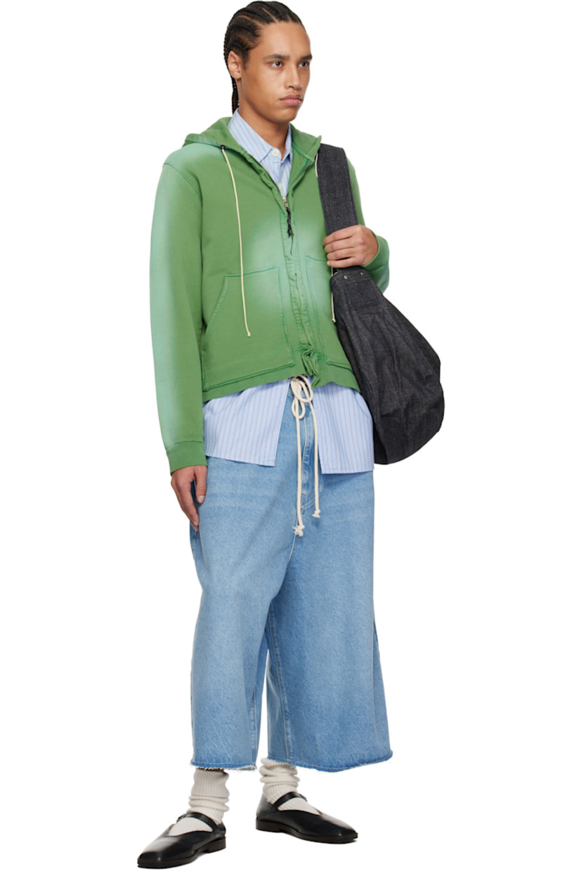 French terry hoodie. Fading and raw edges throughout.

· Cord-lock drawstring at hood
· Zip closure
· Asymmetric patch pockets and hem

Supplier color: Green sun faded
