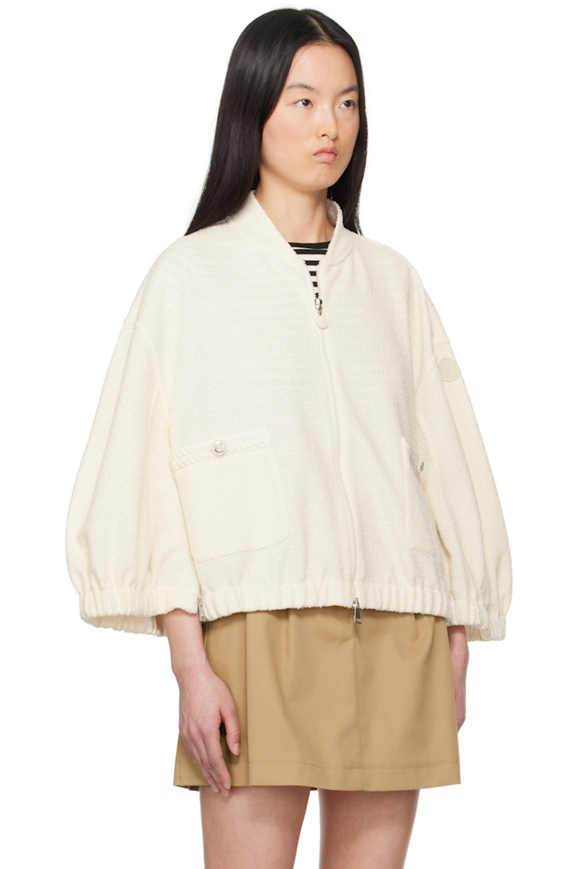 Bouclé knit stretch polyester- and cotton-blend jacket.

· Stand collar
· Two-way zip closure
· Mock patch pockets 
· Elasticized hem and cuffs
· Zip vent at side seams 
· Embroidered logo patch at sleeve

Supplier color: White