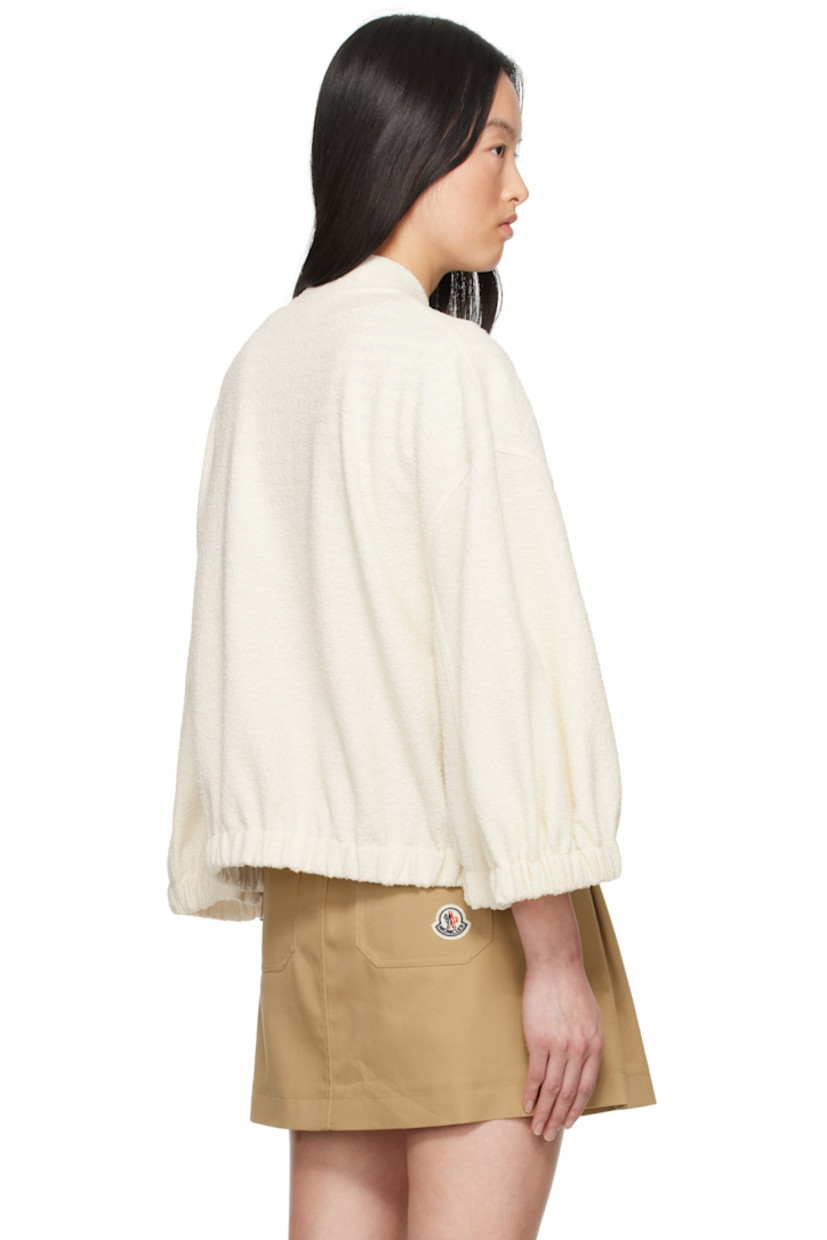 Bouclé knit stretch polyester- and cotton-blend jacket.

· Stand collar
· Two-way zip closure
· Mock patch pockets 
· Elasticized hem and cuffs
· Zip vent at side seams 
· Embroidered logo patch at sleeve

Supplier color: White