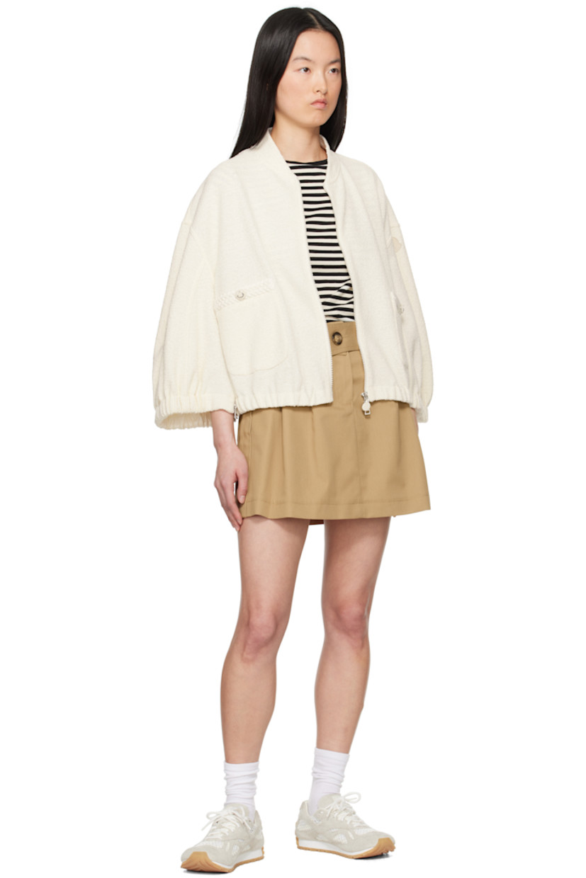 Bouclé knit stretch polyester- and cotton-blend jacket.

· Stand collar
· Two-way zip closure
· Mock patch pockets 
· Elasticized hem and cuffs
· Zip vent at side seams 
· Embroidered logo patch at sleeve

Supplier color: White