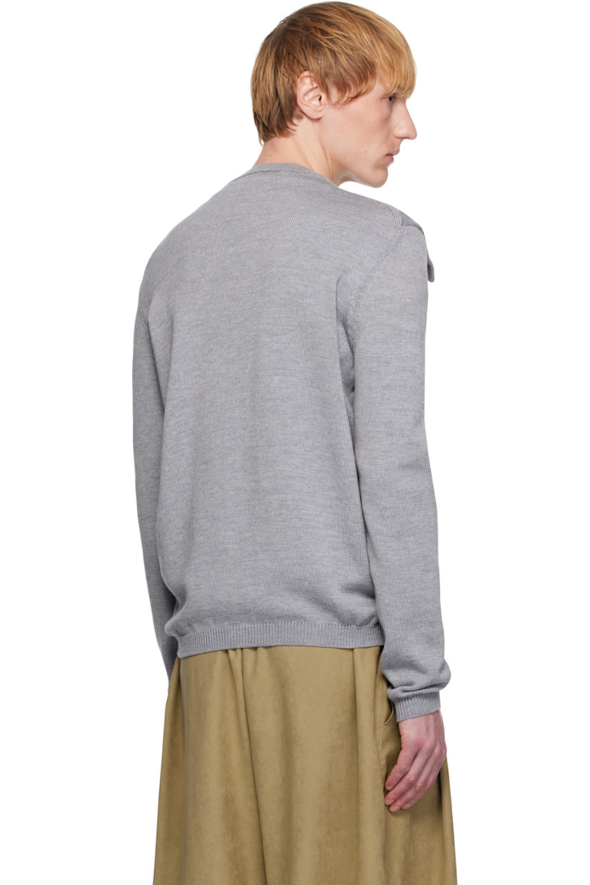 Knit merino wool cardigan.

· Rib-knit round neck, hem, and cuffs
· Bow appliqué at collar
· Button closure

Supplier color: Grey