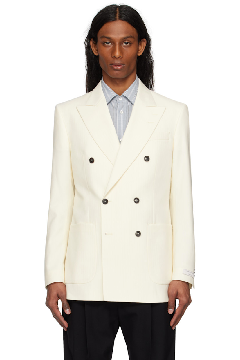 Wool twill blazer. 

· Peaked lapel
· Double-breasted button closure
· Patch pockets
· Padded shoulders
· Surgeon's cuffs
· Vents at back hem
· Welt pockets at interior
· Full satin lining

Supplier color: Light ivory