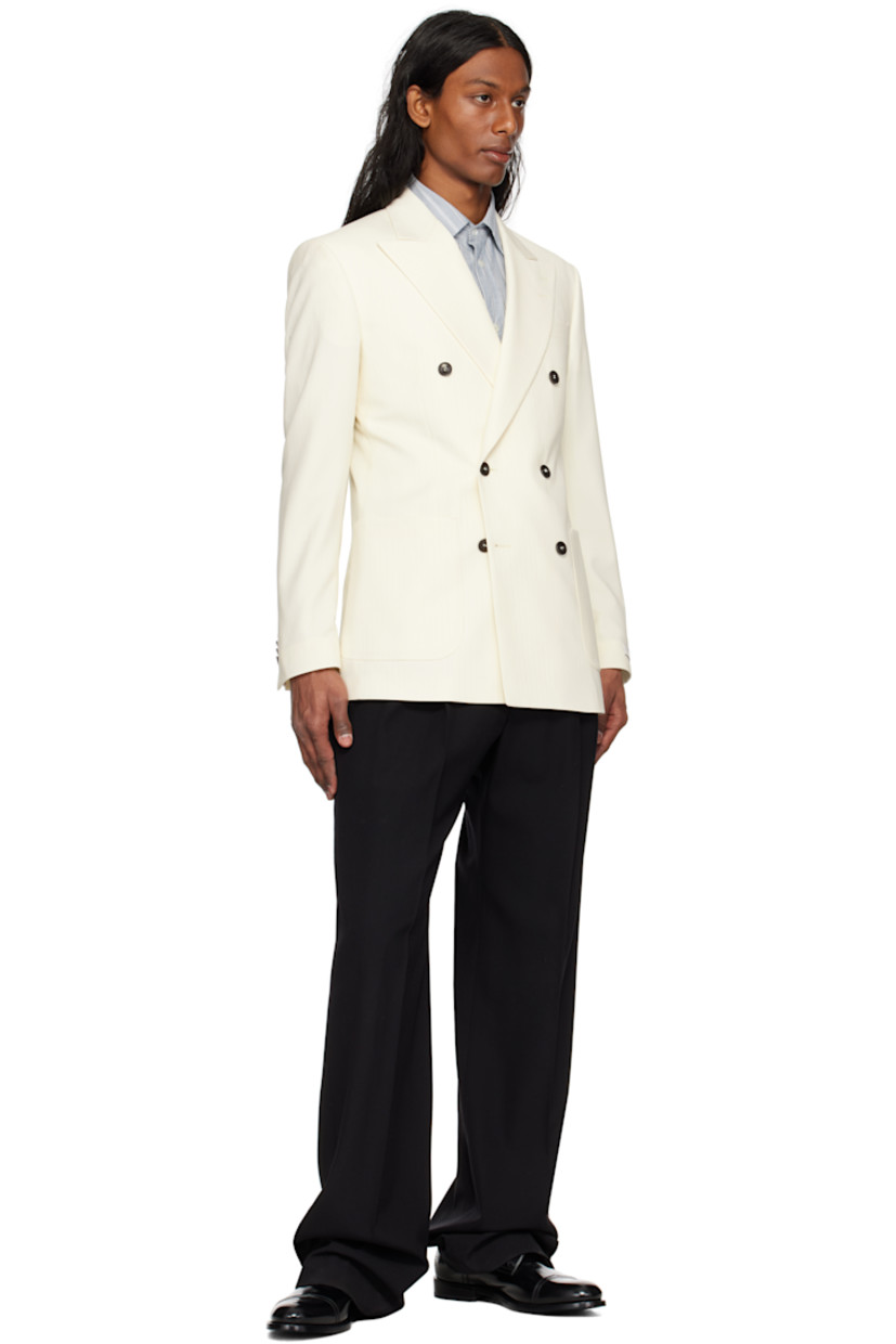 Wool twill blazer. 

· Peaked lapel
· Double-breasted button closure
· Patch pockets
· Padded shoulders
· Surgeon's cuffs
· Vents at back hem
· Welt pockets at interior
· Full satin lining

Supplier color: Light ivory