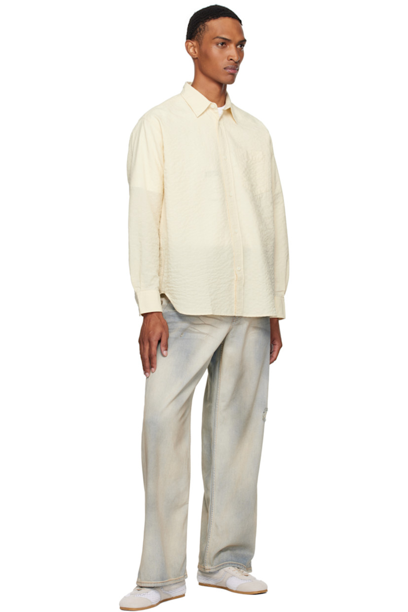Stretch cotton-blend seersucker shirt. Check pattern throughout.

· Spread collar
· Button closure
· Patch pocket at chest
· Shirttail hem
· Buttoned barrel cuffs
· Box pleat at back yoke

Supplier color: Oatmeal