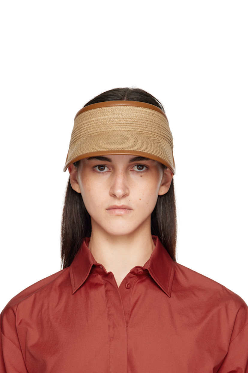 Woven paper visor. 

· Curved brim
· Logo hardware at side
· Adjustable elasticized cinch strap at back face
· Satin browband

Supplier color: Tobacco