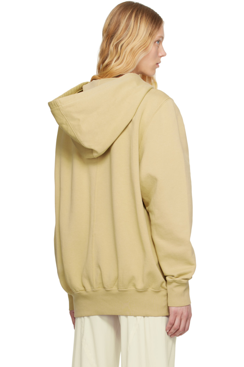 GOTS-certified organic cotton fleece hoodie.

· Drawstring at hood
· Rib-knit hem and cuffs
· Saddle shoulders
· Central seam at back
· Logo-woven webbing strap at interior

Supplier color: Parchment