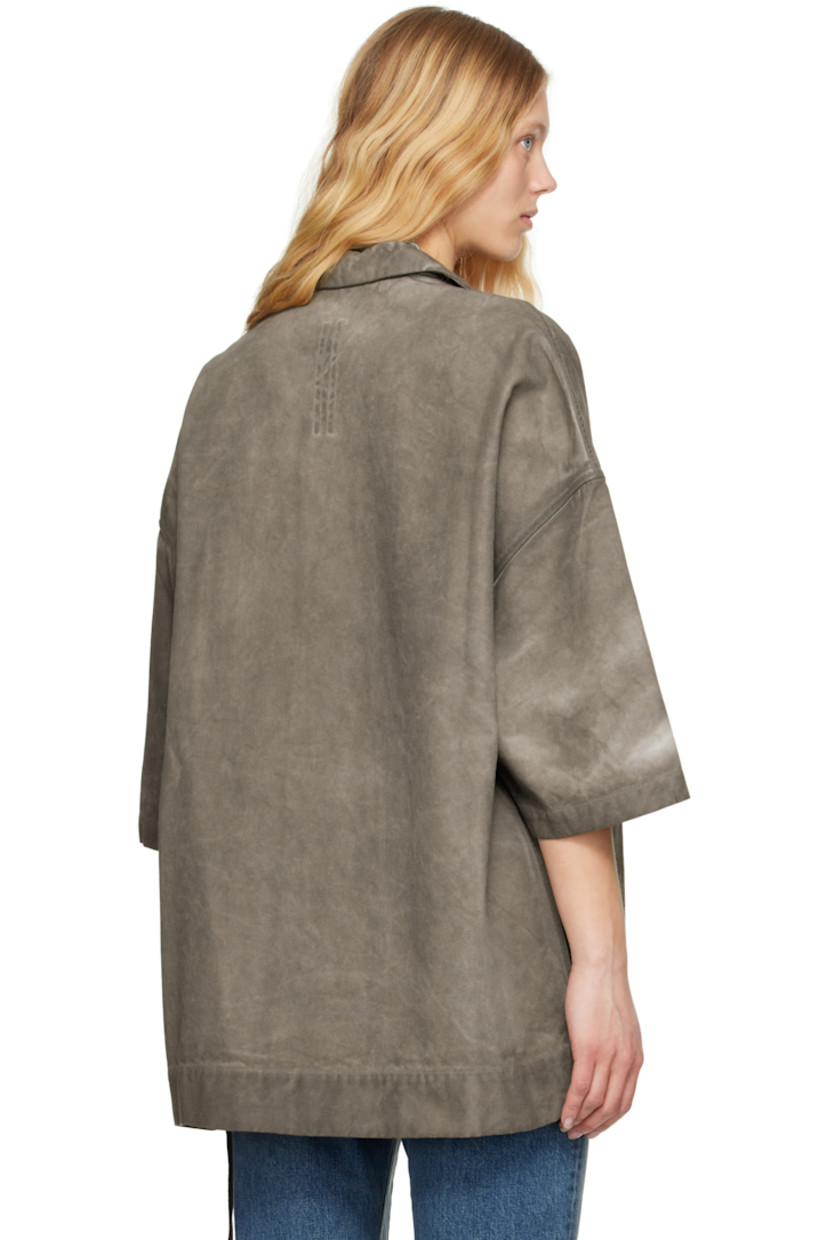 Foil-coated and garment-dyed organic cotton canvas shirt. Fading throughout.

· GOTS-certified organic cotton
· Open spread collar
· Button closure
· Flap pockets
· Logo-woven webbing strap at interior 

Each item is unique. Please note that coloration and finishing may vary.

Supplier color: Dust