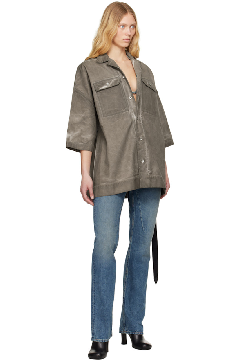 Foil-coated and garment-dyed organic cotton canvas shirt. Fading throughout.

· GOTS-certified organic cotton
· Open spread collar
· Button closure
· Flap pockets
· Logo-woven webbing strap at interior 

Each item is unique. Please note that coloration and finishing may vary.

Supplier color: Dust