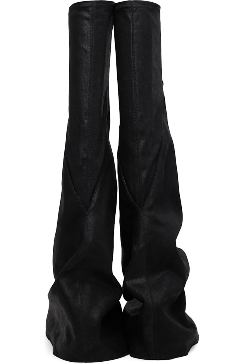 Thigh-high 13 oz denim boots.

· Overdyed and foil-coated
· ZDHC-certified denim
· Layered construction
· Concealed faux-leather cap toe
· Elasticized collar
· Treaded rubber sole

Supplier color: Black/Milk/Milk