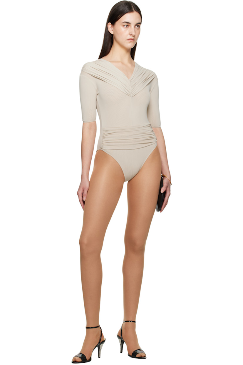 Stretch nylon mesh bodysuit.

· Ruching at V-neck
· Ruched panel at waist
· Elasticized cuffs

Supplier color: Cream