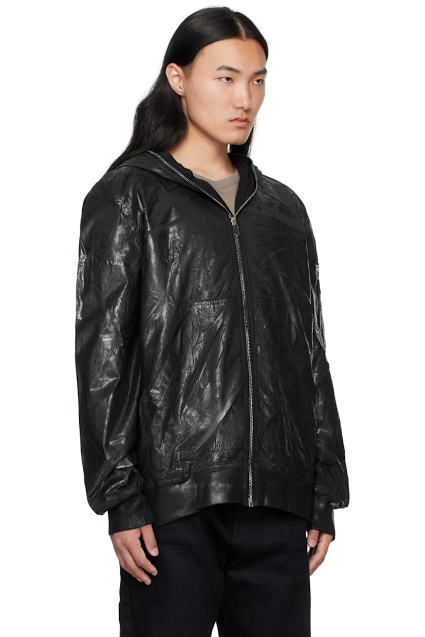 Padded lightweight organic cotton poplin bomber jacket.

· Foil-coated and garment-dyed
· GOTS-certified organic cotton
· Cutout and metal eyelets at hood
· Zip closure extends to hood
· Patch pockets
· Rib-knit hem and cuffs
· Welt pockets at interior
· Integrated logo-woven strap at interior
· Full satin and poplin lining

Supplier color: Black
