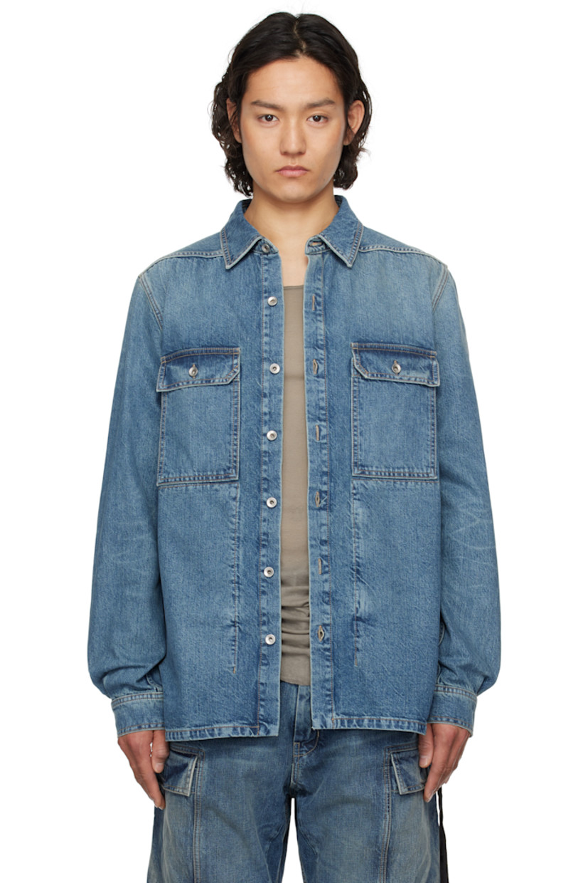 13 oz non-stretch selvedge denim overshirt. Subtle fading throughout.

· ZDHC-certified
· Garment-washed
· Spread collar
· Button closure
· Flap pockets
· Droptail hem
· Beveled side seams
· Saddle shoulders
· Adjustable button fastening at cuffs
· Webbing strap at back yoke
· Zip pockets at interior
· Integrated logo-woven strap
· Silver-tone hardware
· Contrast stitching in tan

Supplier color: Washed indigo
