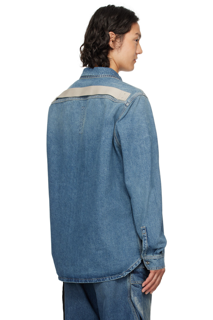 13 oz non-stretch selvedge denim overshirt. Subtle fading throughout.

· ZDHC-certified
· Garment-washed
· Spread collar
· Button closure
· Flap pockets
· Droptail hem
· Beveled side seams
· Saddle shoulders
· Adjustable button fastening at cuffs
· Webbing strap at back yoke
· Zip pockets at interior
· Integrated logo-woven strap
· Silver-tone hardware
· Contrast stitching in tan

Supplier color: Washed indigo