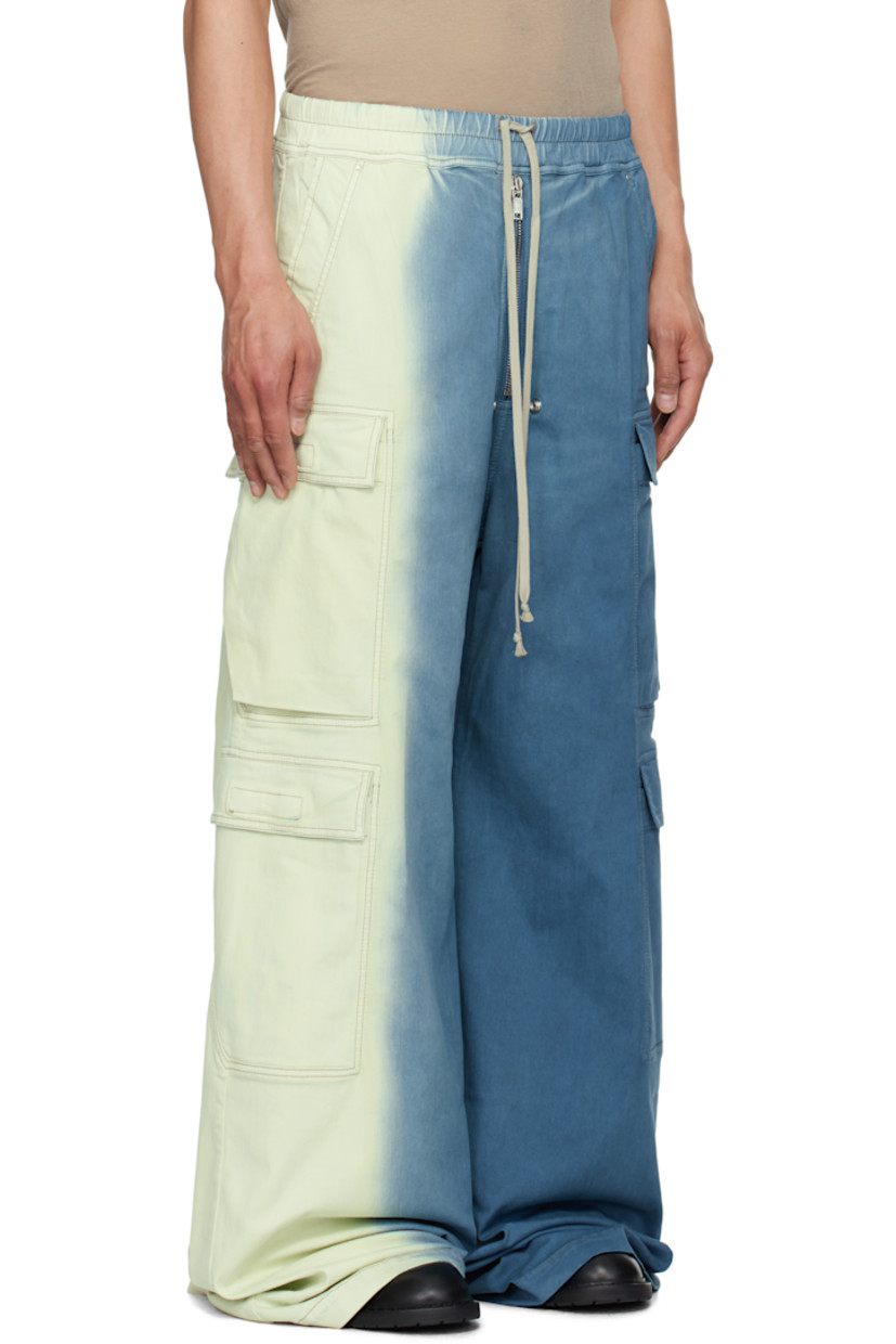 Overdyed 10 oz stretch denim cargo pants. Gradient throughout.

· ZDHC-certified
· Wide-leg
· Drawstring at elasticized waistband
· Four-pocket styling
· Exposed zip fly
· Eyelets and rivets at front
· Creased legs
· Extended hem
· Dropped inseam
· Cargo pockets at outseams

Supplier color: Toothpaste degrade