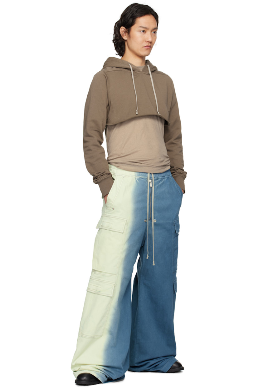 Overdyed 10 oz stretch denim cargo pants. Gradient throughout.

· ZDHC-certified
· Wide-leg
· Drawstring at elasticized waistband
· Four-pocket styling
· Exposed zip fly
· Eyelets and rivets at front
· Creased legs
· Extended hem
· Dropped inseam
· Cargo pockets at outseams

Supplier color: Toothpaste degrade