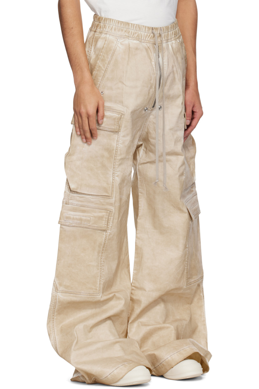 Overdyed and foil-coated stretch denim cargo pants. Fading and creases throughout.

· Wide-leg
· Drawstring at elasticized waistband
· Four-pocket styling
· Exposed zip fly
· Eyelets and rivets at front 
· Extended hem
· Dropped inseam
· Cargo pockets at outseams

Supplier color: Parchment