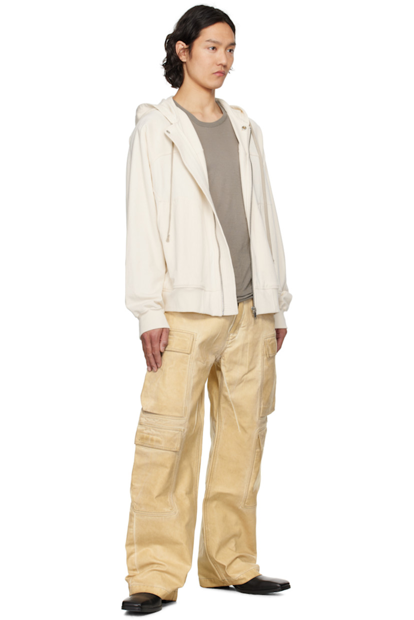 Overdyed and foil-coated 13 oz non-stretch organic cotton denim jeans. Fading throughout.

· GOTS- and ZDHC-certified
· Loose-fit
· Low-rise
· Belt loops
· Five-pocket styling
· Zip fly
· Cargo pockets at outseams 
· Contrast stitching in taupe

Each item is unique. Please note finishings may vary.

Supplier color: Parchment