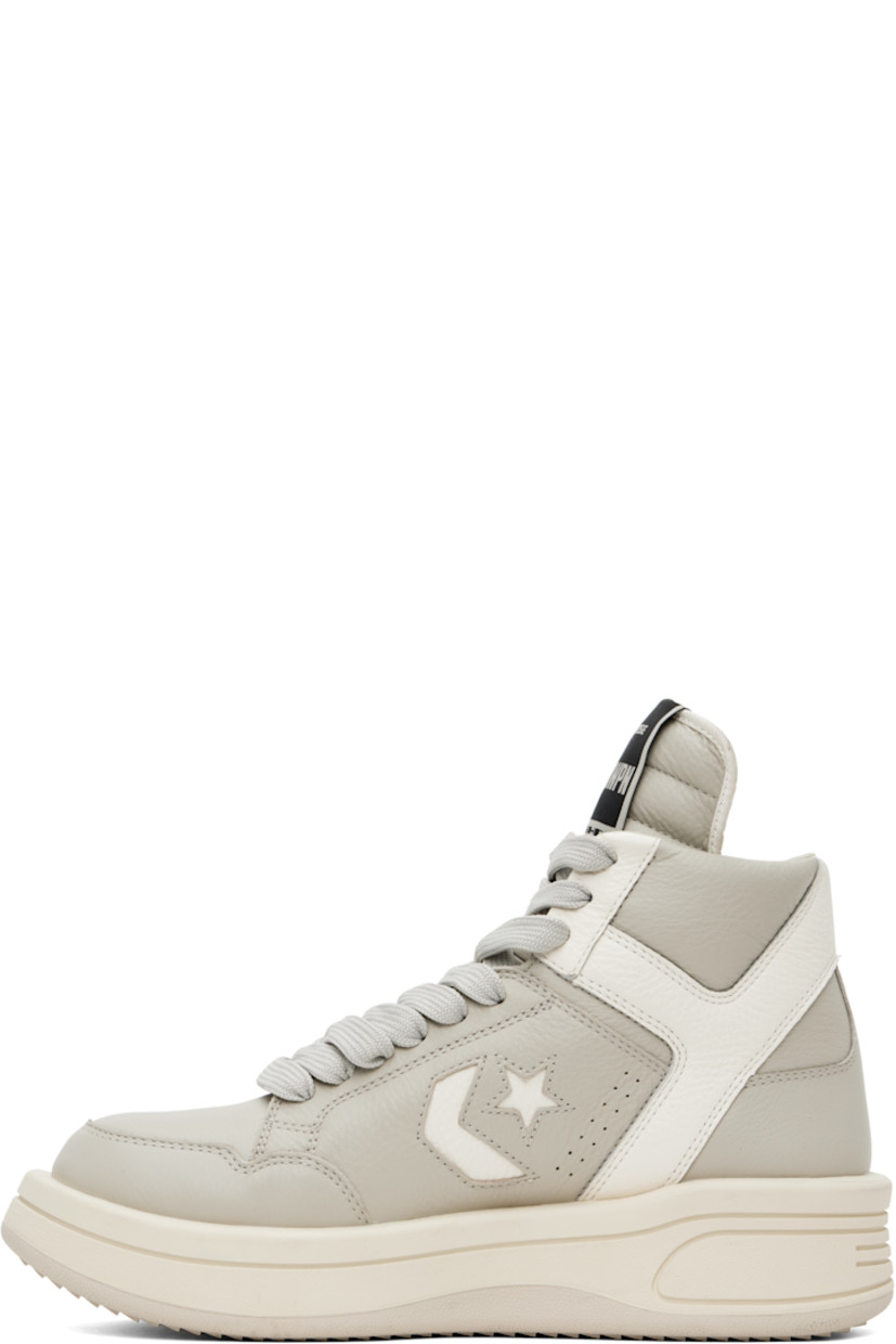 High-top grained leather sneakers in off-white.

· Perforated detailing throughout
· Lace-up closure
· Logo patch at padded tongue
· Padded collar
· Logo cutout at sides
· Buffed faux-leather lining
· Treaded rubber platform sole
· Platform: H2"

Part of the Rick Owens DRKSHDW x Converse collaboration.

Supplier color: Oyster/White