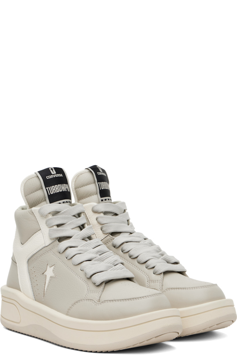 High-top grained leather sneakers in off-white.

· Perforated detailing throughout
· Lace-up closure
· Logo patch at padded tongue
· Padded collar
· Logo cutout at sides
· Buffed faux-leather lining
· Treaded rubber platform sole
· Platform: H2"

Part of the Rick Owens DRKSHDW x Converse collaboration.

Supplier color: Oyster/White