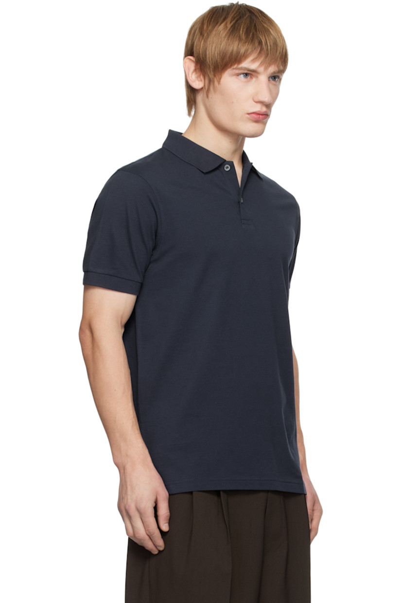 Supima cotton piqué polo. 

· Rib-knit spread collar and cuffs
· Two-button placket
· Tennis-tail hem
· Logo-engraved shell hardware

Supplier color: Navy