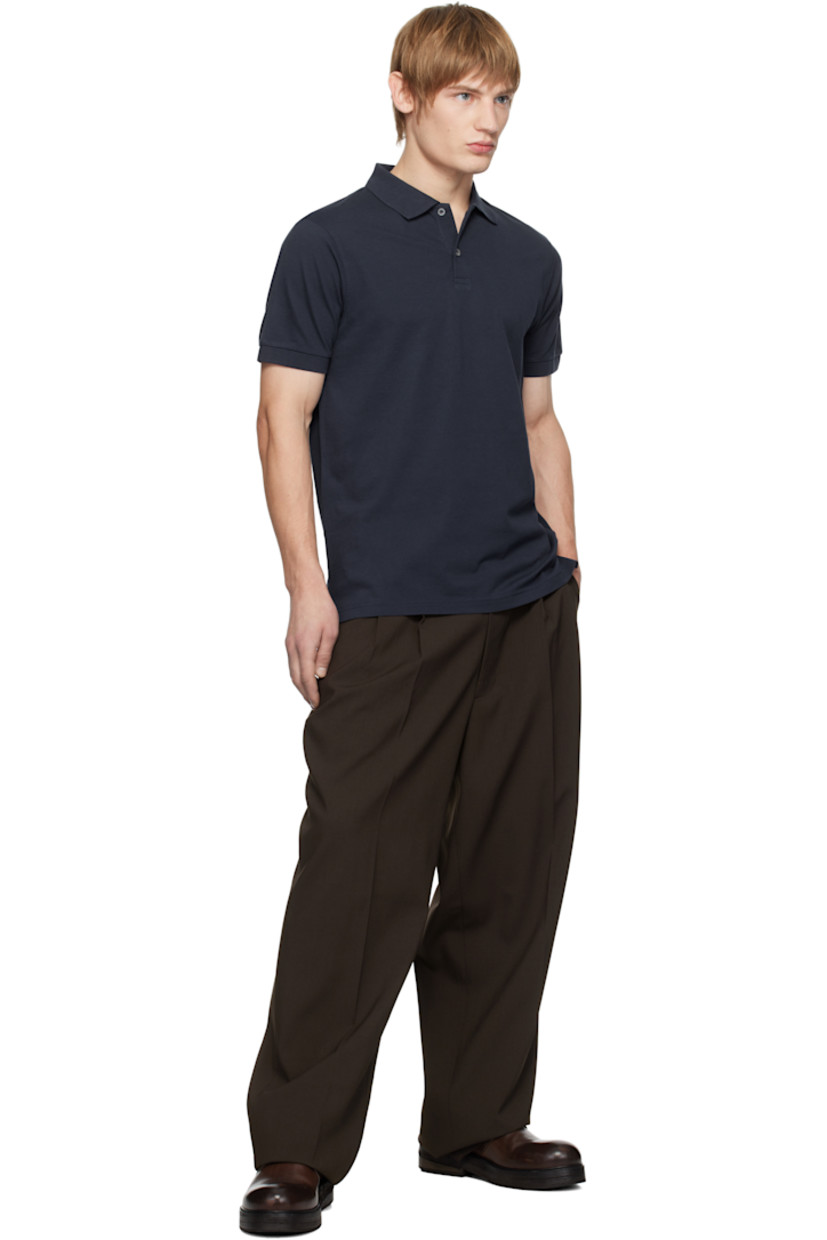 Supima cotton piqué polo. 

· Rib-knit spread collar and cuffs
· Two-button placket
· Tennis-tail hem
· Logo-engraved shell hardware

Supplier color: Navy