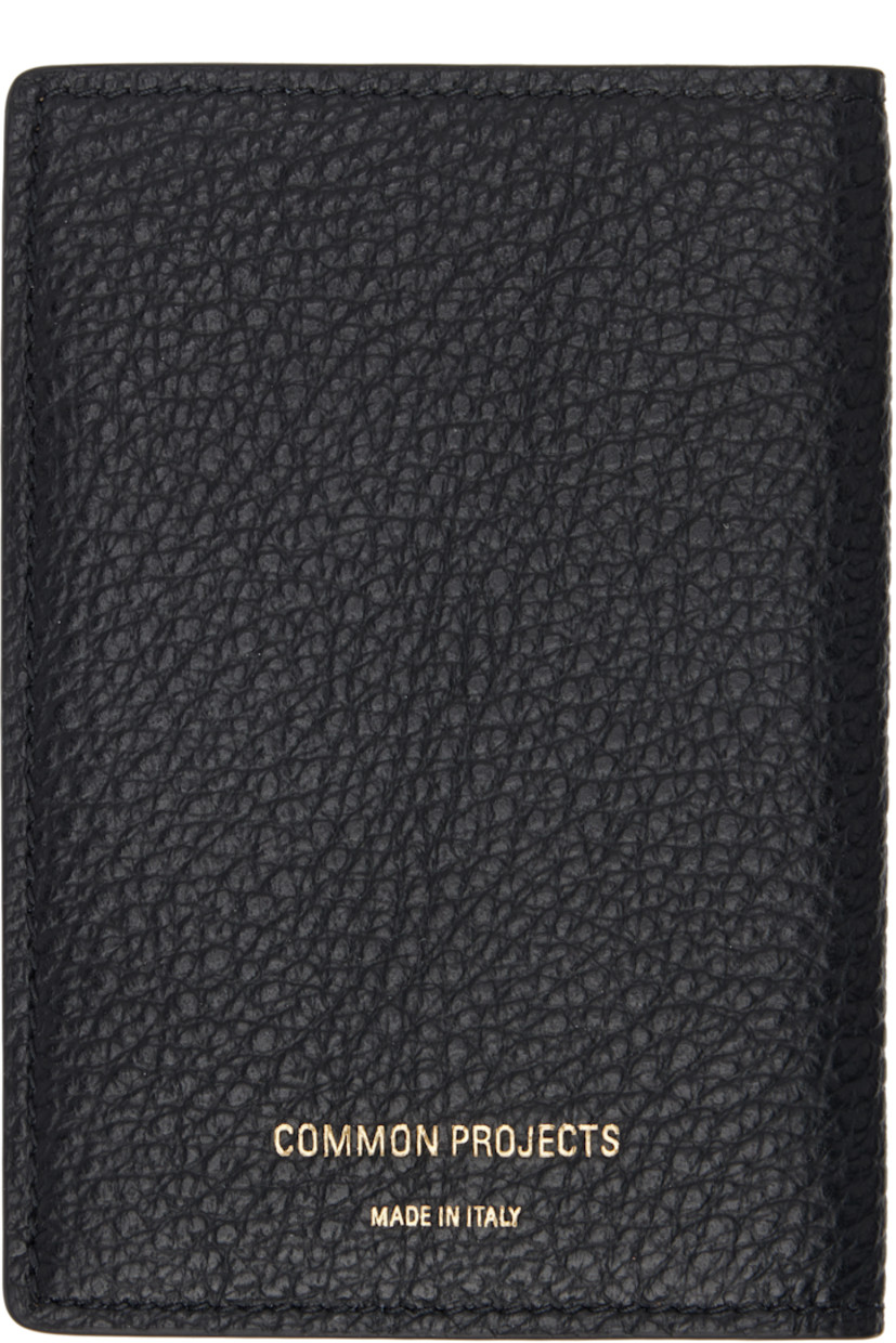 Grained calfskin bifold wallet in black.

· Logo stamp at back face
· Three card slots
· Three patch pockets
· Moiré lining
· H4.5" x W3" x D0.25"

Supplier color: Black