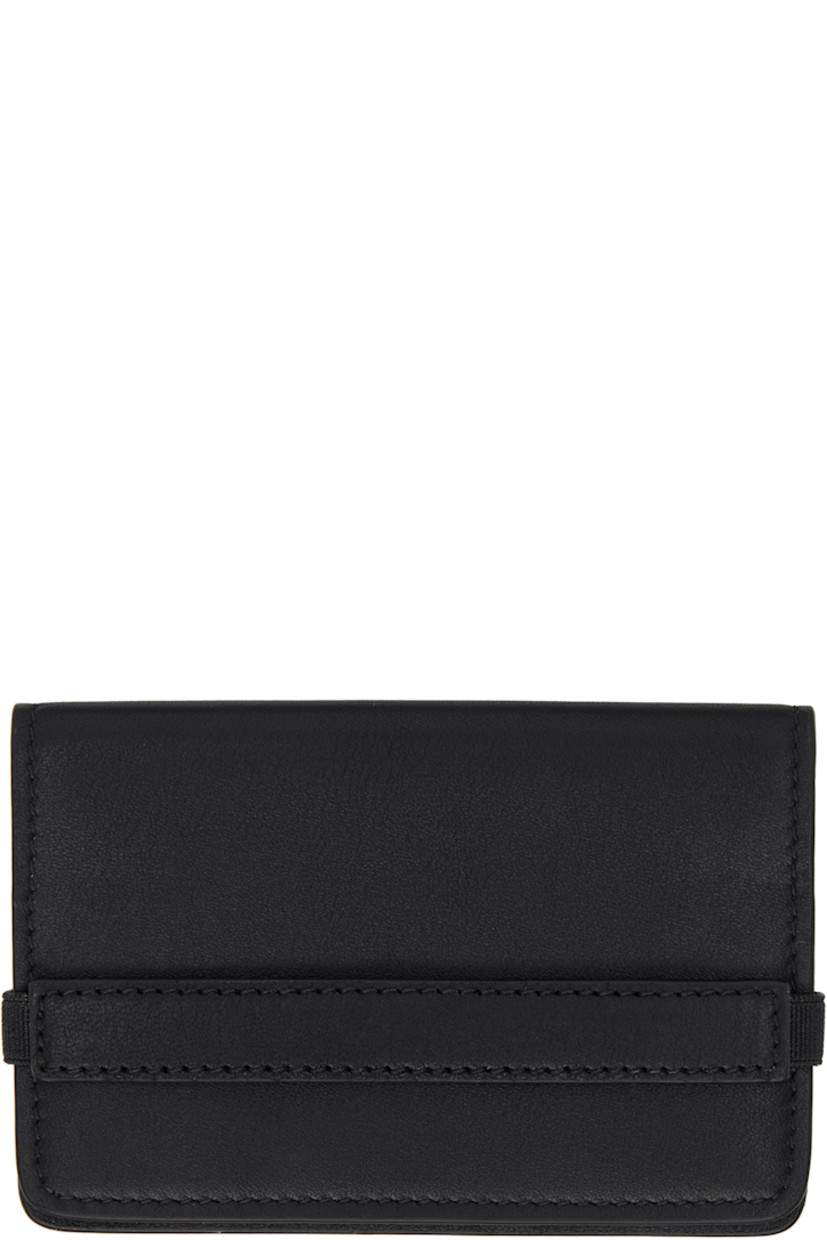 Buffed leather bifold wallet in black.

· Partially elasticized strap at face
· Accordion panel at sides
· Logo stamp at back face
· Two card slots at interior
· One note slot
· Buffed leather lining
· H5.5" x W4" x D0.5"

Supplier color: Black